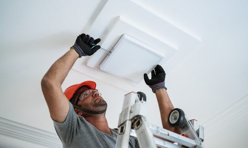 Latino,Electrician,Installing,A,Led,Light,On,The,Ceiling.